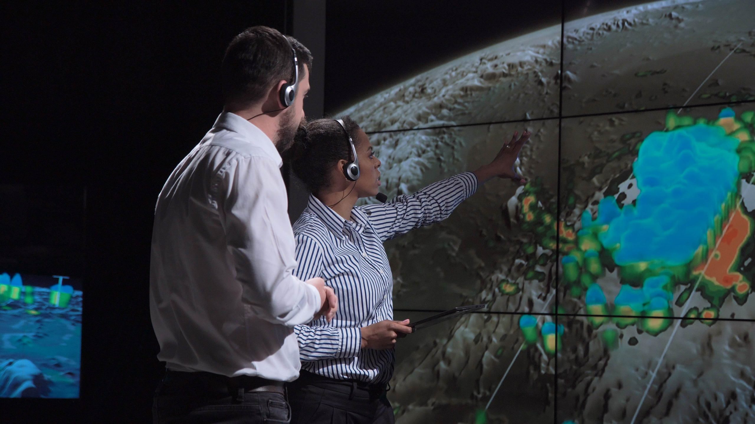 Group,Of,Two,Scientists,Observing,And,Tracking,Hurricane,On,Map